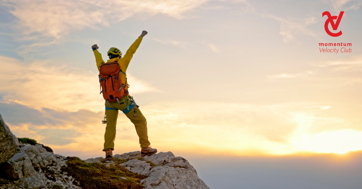 A man standing at the top of a mountain with his arms stretched upwards. Each step he took, each financial decision he made, moved him toward the summit of his dreams. While sometimes challenging, the view from the top is worth it.