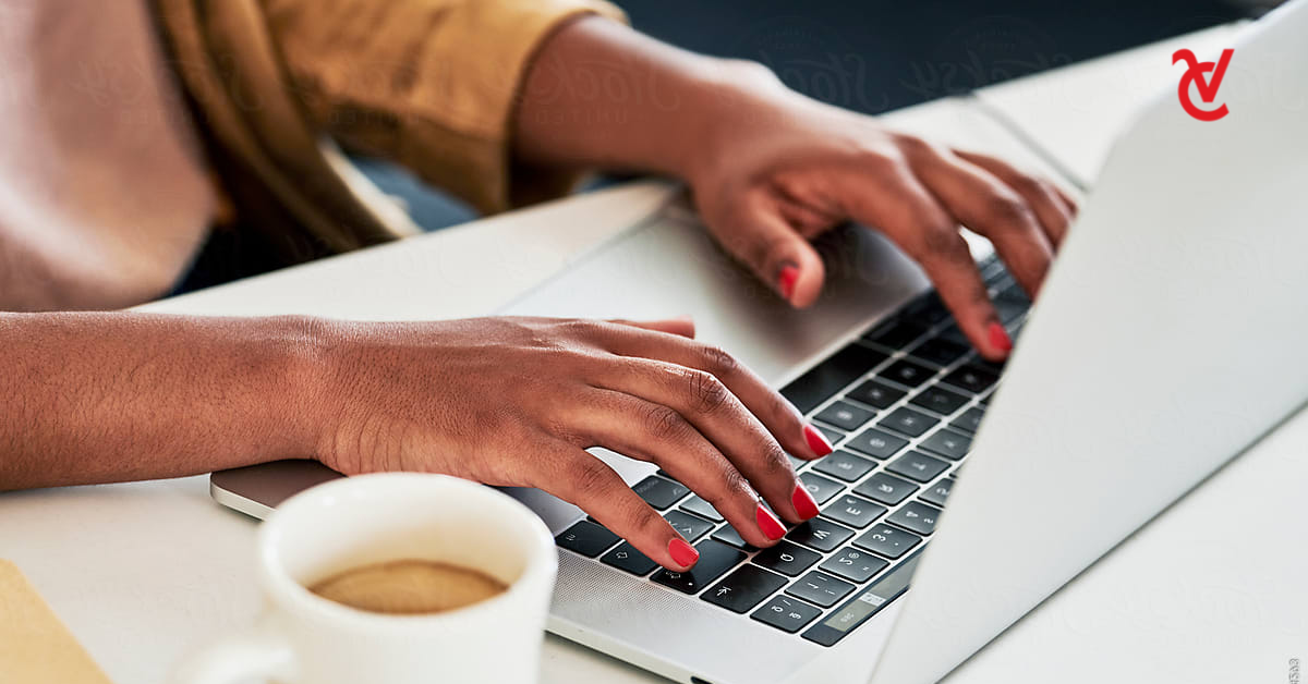 A woman's hands on a laptop. She's setting up reoccurring debit orders on her bank account.