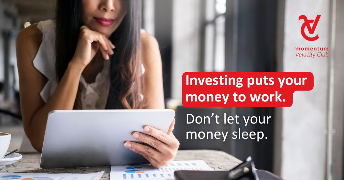 A Momentum Velocity Club client reviewing her investments on her tablet device.