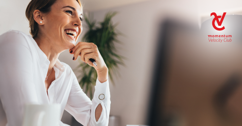 A woman confidently smiles, knowing her taxes are up-to-date.