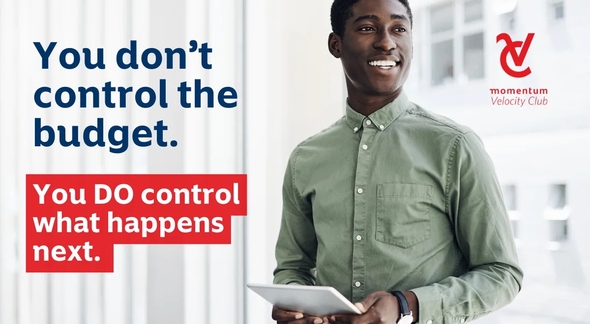 Male professional in a modern office, reviewing his financial documents on his tablet with a calm, confident expression, suggesting control over personal finances despite national budget changes.