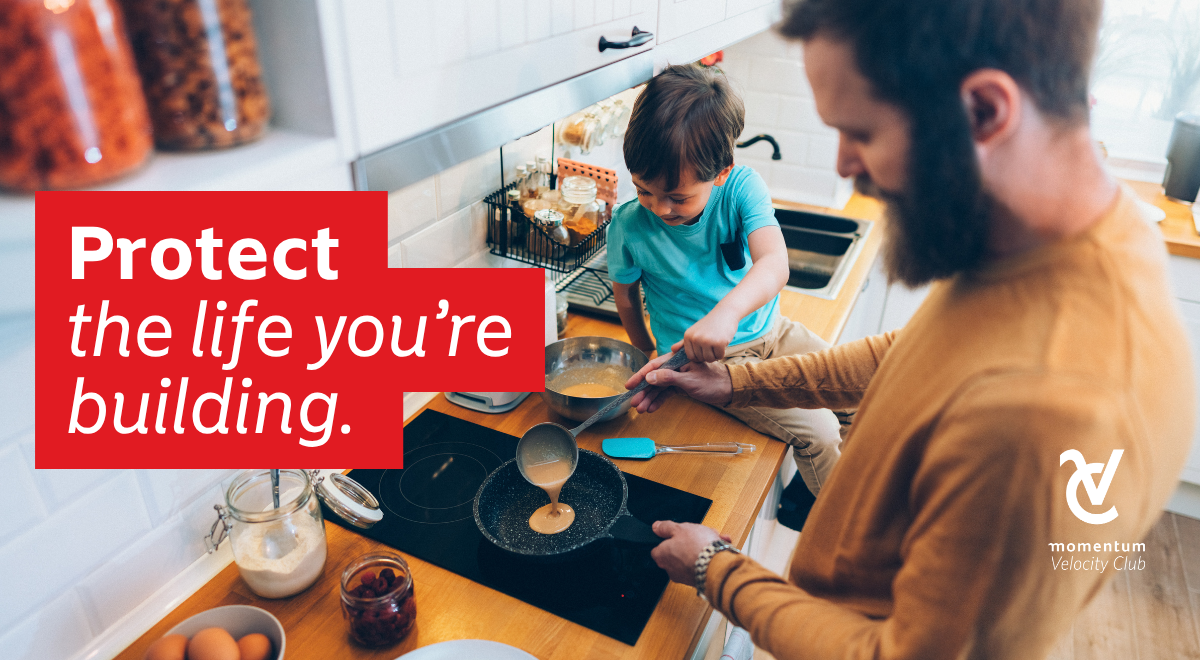 A father and son cooking breakfast in a kitchen, representing financial stability, with the overlay text 