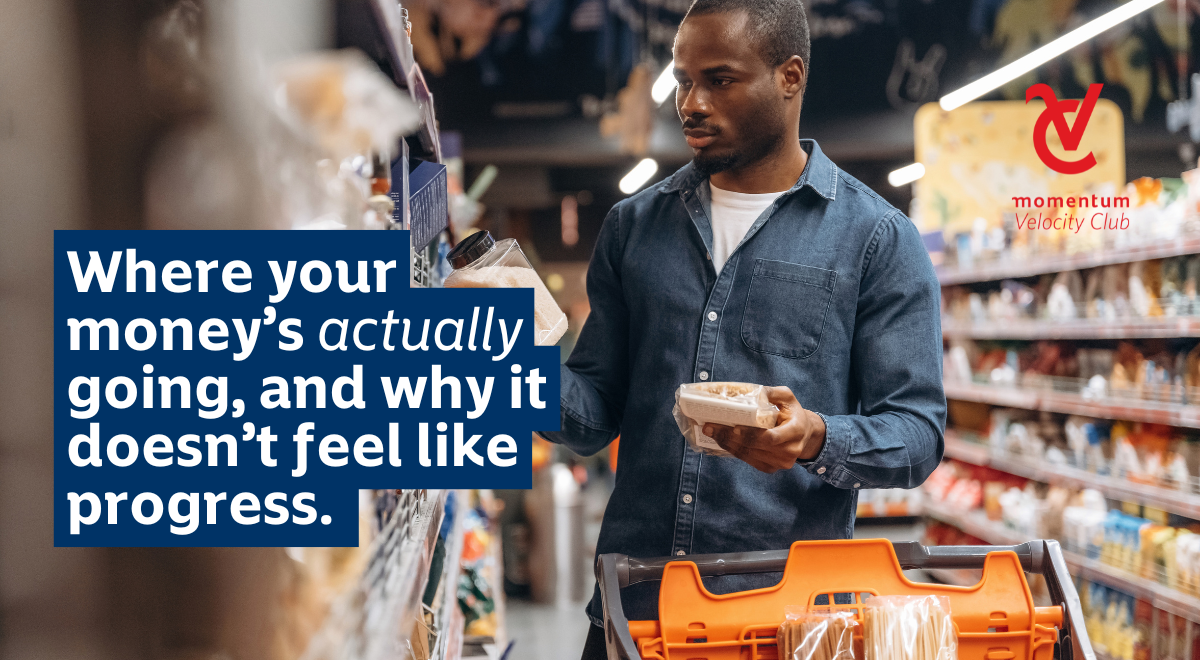 An African man shopping, in the isle of a supermarket putting groceries into his trolley.