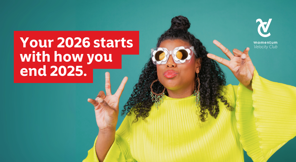 A young woman wearing retro-style glasses and a bright green shirt, smiling and flashing peace signs, representing optimism, confidence, and a fresh start for the new year.